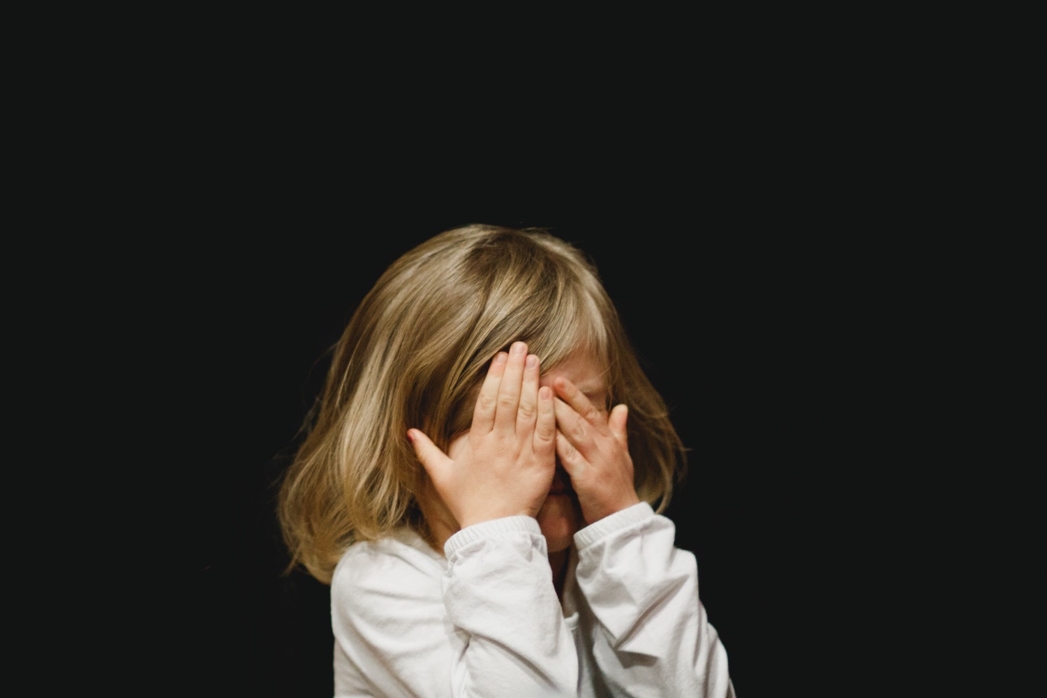 Child covering eyes
