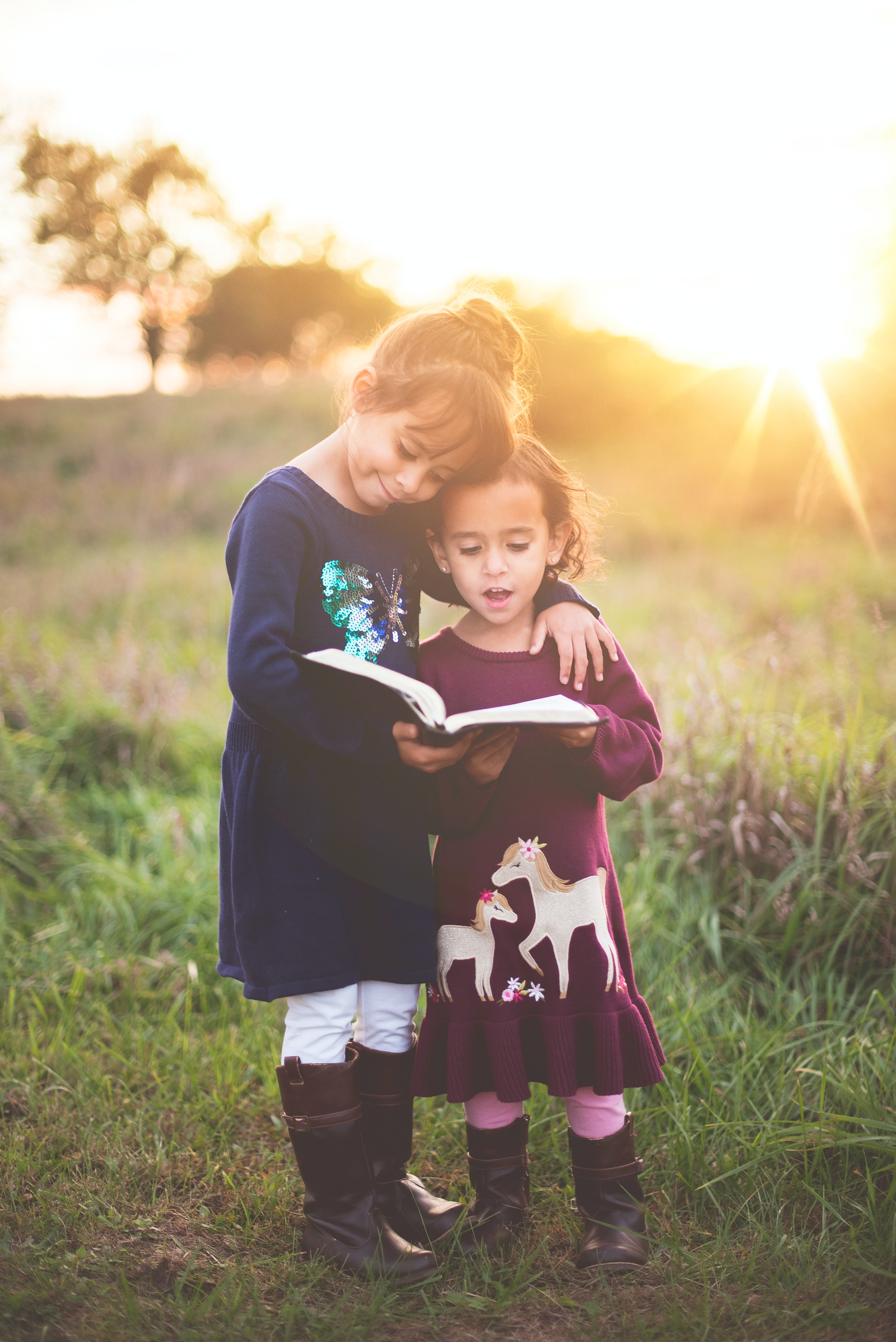 Two Girls Reading Book Outside