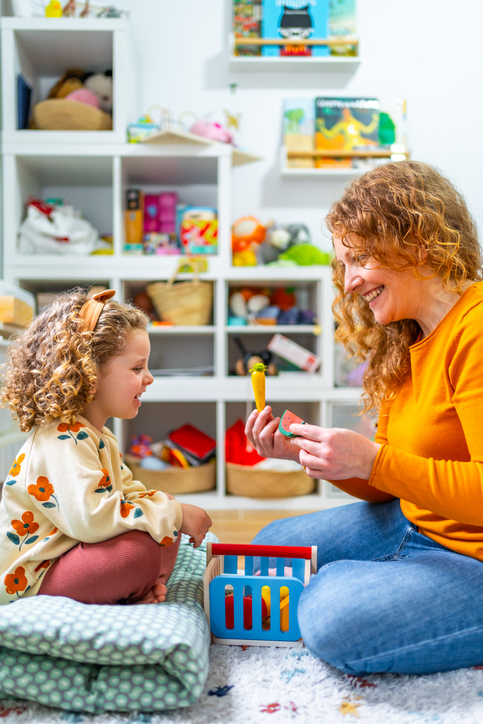 Practitioner engaged in play-based learning